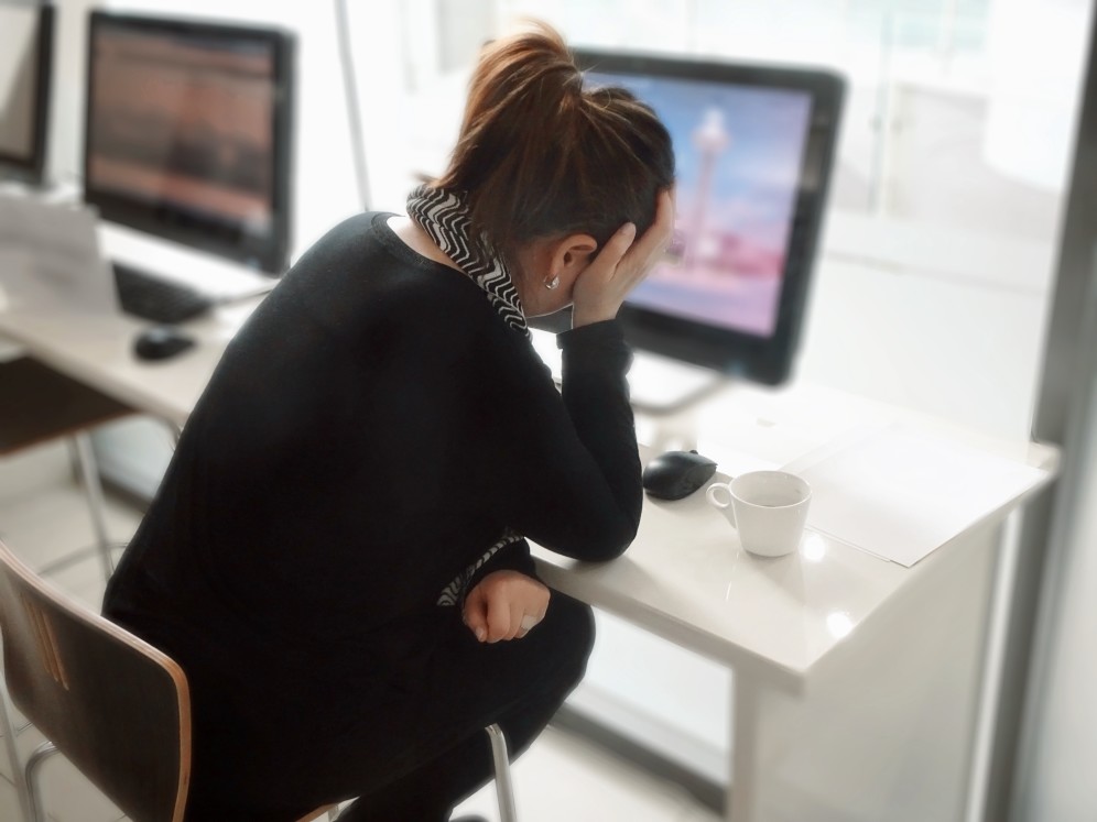 stressed professional woman in front of computer screen